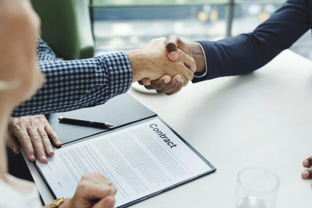 Managers reviewing a staff augmentation contract before engagement